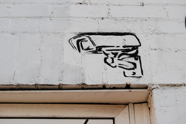 Surveillance camera stencil art. Photo by Paul Lowry via Flickr (CC BY 2.0)