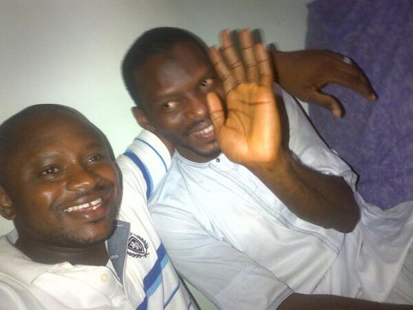 Yusuf Siyaka Onimisi (waving) with Lawal Haruna (@lawalharuna) shortly after his release. Photo from  @lawalharuna.